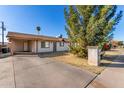 Single-story home boasting a concrete mailbox and shade tree in the front yard at 658 S Sycamore St, Mesa, AZ 85202