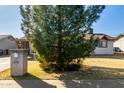 A charming single-story home with a lush tree providing shade in the front yard at 658 S Sycamore St # Value, Mesa, AZ 85202