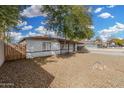 Street view of a single story home with desert landscaping and mature shade trees at 7022 N 26Th Dr, Phoenix, AZ 85051