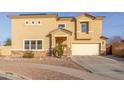 Two-story home featuring a two car garage, neutral color scheme, and desert landscaping at 7611 S 15Th St, Phoenix, AZ 85042