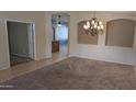 Spacious dining room showcasing a chandelier and doorway to another room at 8014 W Beaubien Dr, Peoria, AZ 85382