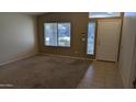 Neutral-toned living room featuring large window and light colored walls at 8014 W Beaubien Dr, Peoria, AZ 85382