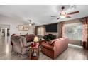 Spacious living room featuring ceiling fans, a large TV, and comfortable seating at 902 W Desert Valley Dr, San Tan Valley, AZ 85143