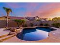 Stunning backyard featuring a dark blue pool, spa and lush landscaping, perfect for relaxation at 9035 W Quail Track Dr, Peoria, AZ 85383