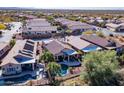 Aerial view showcases the property's serene backyard pool, lush landscaping, and proximity to nearby residences in a peaceful community at 9796 E Stone Cir Ln, Gold Canyon, AZ 85118