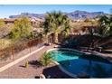 Private backyard pool area with desert landscaping and a beautiful mountain view, offering a serene outdoor retreat at 9796 E Stone Cir Ln, Gold Canyon, AZ 85118