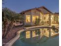 Backyard oasis featuring a refreshing pool, covered patio, and relaxed seating area at 9796 E Stone Cir Ln, Gold Canyon, AZ 85118