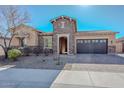 Beautiful single-story home featuring desert landscaping, stone accents, and a convenient two-car garage at 10039 W Jasmine Trl, Peoria, AZ 85383