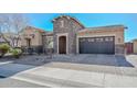 Beautiful single-story home featuring desert landscaping, stone accents, and a convenient two-car garage at 10039 W Jasmine Trl, Peoria, AZ 85383