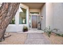 Beautiful entryway featuring a solid wood door, tiled flooring, and desert landscape views at 10040 E Happy Valley Rd # 249, Scottsdale, AZ 85255