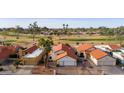 Charming single-Gathering home with a red tile roof and a well-manicured lawn at 10617 E Michigan Ave, Sun Lakes, AZ 85248