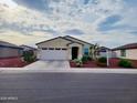 Inviting single-story home with a two-car garage, well-manicured landscaping, and a neutral color palette at 1418 E Peggy Dr, Casa Grande, AZ 85122
