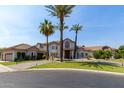 Landscaped front yard with mature palms complements this luxury home with a circular driveway at 1502 E Treasure Cove Dr, Gilbert, AZ 85234