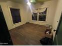 Vacant bedroom with original hardwood floors and natural light from two windows at 1637 E Brill St, Phoenix, AZ 85006