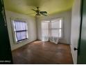 A bedroom with hardwood floors, natural light, and ceiling fan at 1637 E Brill St, Phoenix, AZ 85006