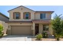 Charming two-story home with neutral stucco, a tile roof, an attached garage and low maintenance landscaping at 16959 W Diana Ave, Waddell, AZ 85355