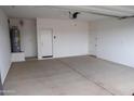 Spacious two car garage with ample room and concrete flooring at 17353 W Via De Luna Dr, Surprise, AZ 85387