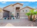 Inviting single-story home featuring desert landscaping, paver walkway, and covered porch at 17637 N Goldwater Dr, Surprise, AZ 85374