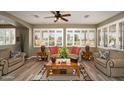 Inviting living room featuring wood floors, ceiling fan, and natural light at 17637 N Goldwater Dr, Surprise, AZ 85374