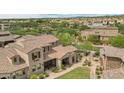 Expansive aerial view of a home with a tile roof, lush landscaping, and a well-maintained yard at 18515 N 94Th St, Scottsdale, AZ 85255