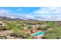 Aerial view of a community pool surrounded by trees, offering a refreshing and scenic amenity at 18515 N 94Th St, Scottsdale, AZ 85255
