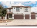 Two-story home featuring a three-car garage, tile roof, and modern design at 20358 N Valencia N Dr, Maricopa, AZ 85138