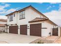 Two-story home featuring a three-car garage, tile roof, and modern design at 20358 N Valencia N Dr, Maricopa, AZ 85138