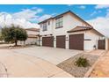 Two-story home featuring a three-car garage, tile roof, and modern design at 20358 N Valencia N Dr, Maricopa, AZ 85138