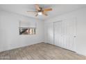 Inviting bedroom with natural light from window, neutral walls, tile flooring, and ceiling fan at 2220 W Dora St # 129, Mesa, AZ 85201