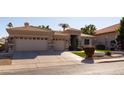 Tan single-story home with a three car garage and stone accents on the facade at 3631 S Greythorne S Way, Chandler, AZ 85248