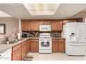 Well-lit kitchen with matching appliances and an eat-in counter at 4122 E Jojoba Rd, Phoenix, AZ 85044