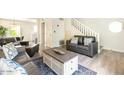 Inviting living room featuring leather sofas, a staircase, and neutral decor at 4620 N 68Th St # 117, Scottsdale, AZ 85251