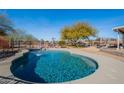 Sparkling pool with a spacious deck for lounging and outdoor entertaining under a sunny blue sky at 532 N 102Nd Pl, Mesa, AZ 85207