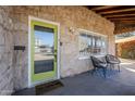 Cozy front porch with chairs and a bright yellow door, welcoming you home at 541 W Edgemont Ave, Phoenix, AZ 85003