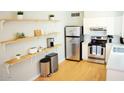 Bright kitchen with stainless steel appliances, white cabinets, and open shelving at 541 W Edgemont Ave, Phoenix, AZ 85003