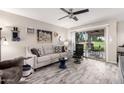 Inviting living room featuring neutral colors, tile floors, ceiling fan, and sliding glass doors leading to outdoor space at 619 S Desert Flower Dr, Mesa, AZ 85208