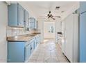 Bright kitchen featuring blue cabinets, a ceiling fan, and tiled floors at 724 S Lewis --, Mesa, AZ 85210