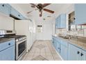 Cozy kitchen featuring blue cabinets, stainless steel appliances, tile floors and granite countertops at 724 S Lewis --, Mesa, AZ 85210