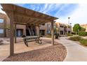 Community common area with covered picnic table and walkway at 8155 E Roosevelt St # 112, Scottsdale, AZ 85257