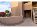 Exterior view of the condo building entrance with stairway access to upper level at 8155 E Roosevelt St # 112, Scottsdale, AZ 85257