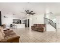 Spacious living room with tiled floors, ceiling fan, and an open layout at 8812 N 67Th Dr, Peoria, AZ 85345
