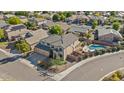 Aerial view of a suburban home with a pool, desert landscaping, and a three car garage at 9237 W Alex Ave, Peoria, AZ 85382