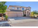 Charming two-story home with a spacious driveway and desert-style landscaping at 9237 W Alex Ave, Peoria, AZ 85382