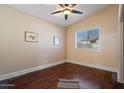 Bedroom with hardwood floors, a ceiling fan, and a bright window at 9718 E Boston St, Mesa, AZ 85207