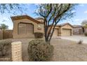 Charming home with a well-maintained desert landscape, three car garage, and neutral stucco at 9734 S 182Nd Dr, Goodyear, AZ 85338