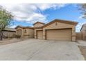 Charming home with a well-maintained desert landscape, spacious driveway, and three-car garage at 9734 S 182Nd Dr, Goodyear, AZ 85338