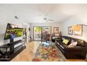 Comfortable living room with sliding glass doors to a patio and golf course views at 9990 N Scottsdale Rd # 1006, Paradise Valley, AZ 85253