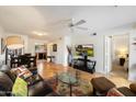Bright living room boasts hardwood floors, a ceiling fan, and an open layout with a kitchen view at 9990 N Scottsdale Rd # 1006, Paradise Valley, AZ 85253