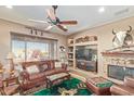 Inviting living room showcases rustic decor, a fireplace, and abundant natural light at 12752 W Junipero Dr, Sun City West, AZ 85375