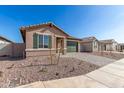 Single-story home with desert landscaping, green garage door, and paver driveway at 13242 W Hackamore Dr, Peoria, AZ 85383